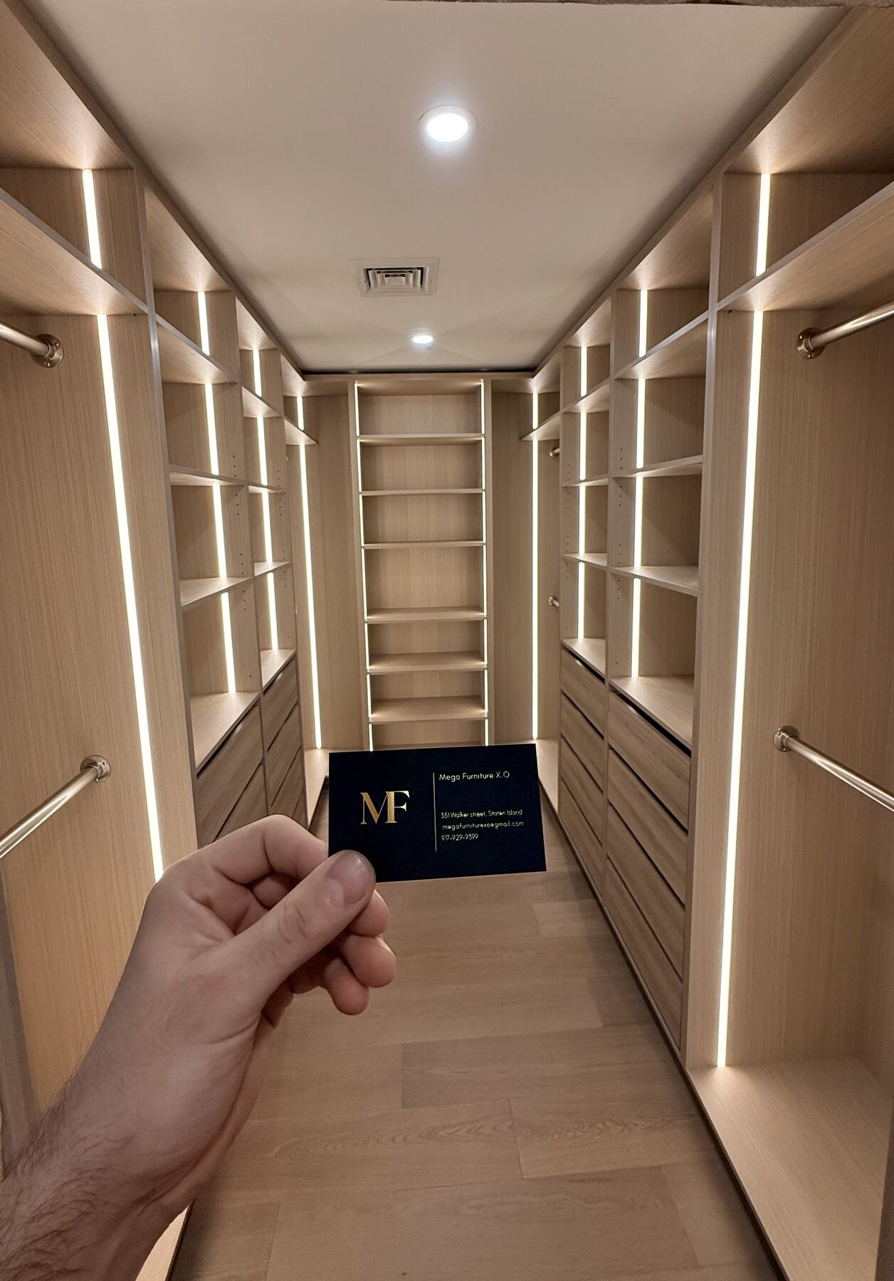 Walk-in closet corridor with built-in shelving and drawers