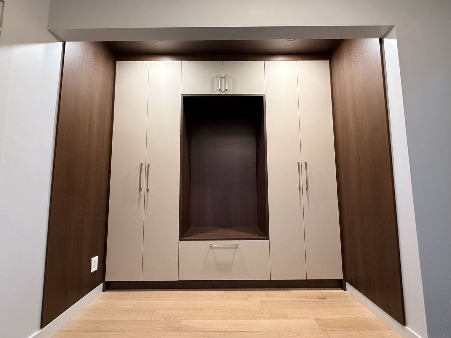 Custom entryway wardrobe with dark wood niche