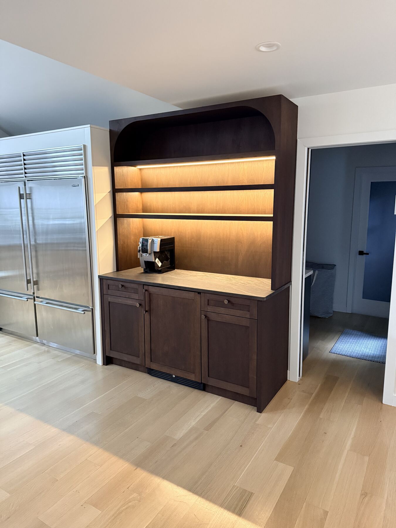 Built-in coffee bar with arched display shelving