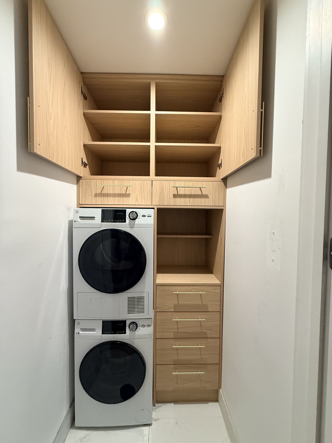 Laundry closet cabinetry with open storage shelves