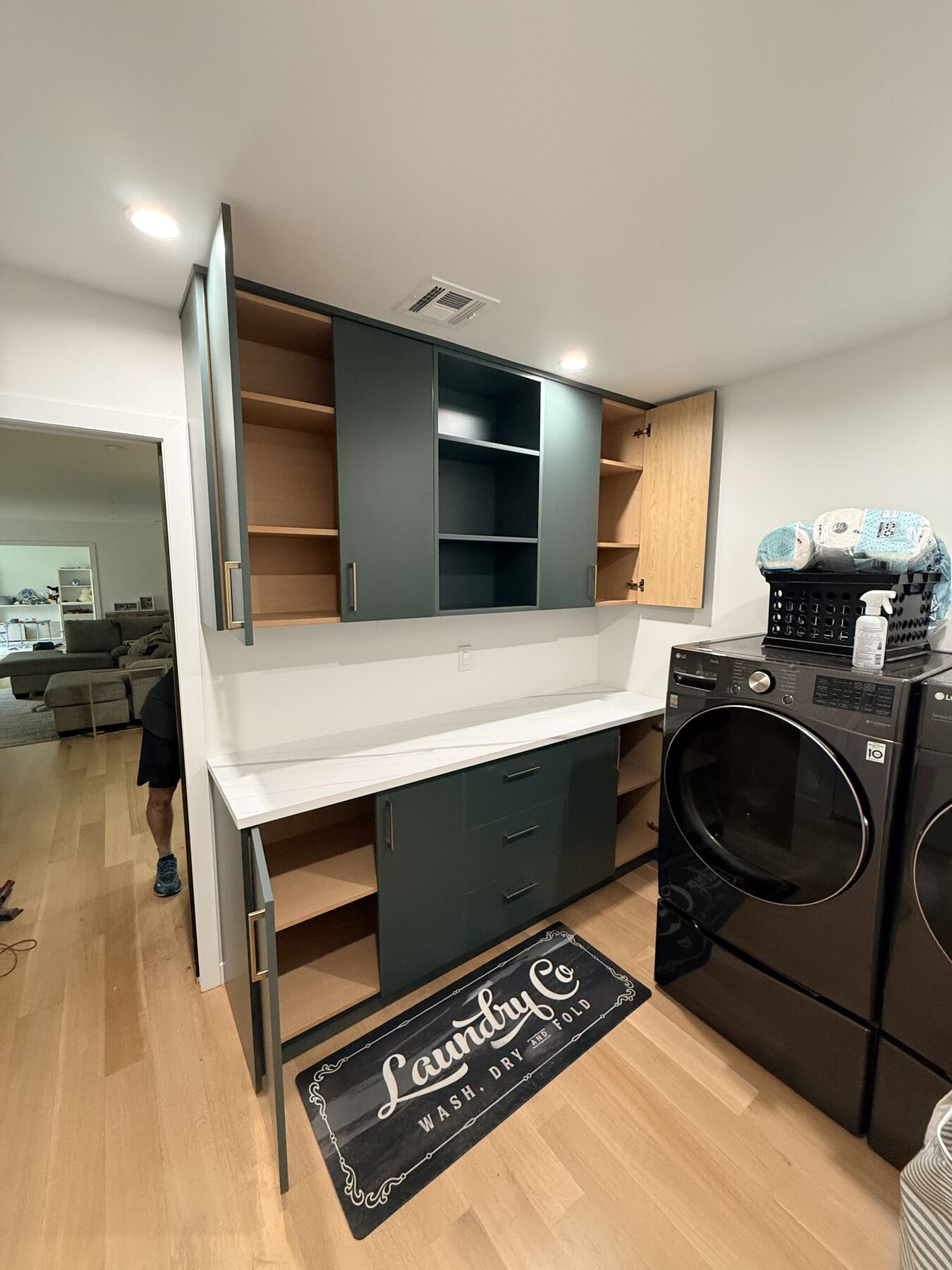 Laundry room cabinetry with open cabinets and shelving