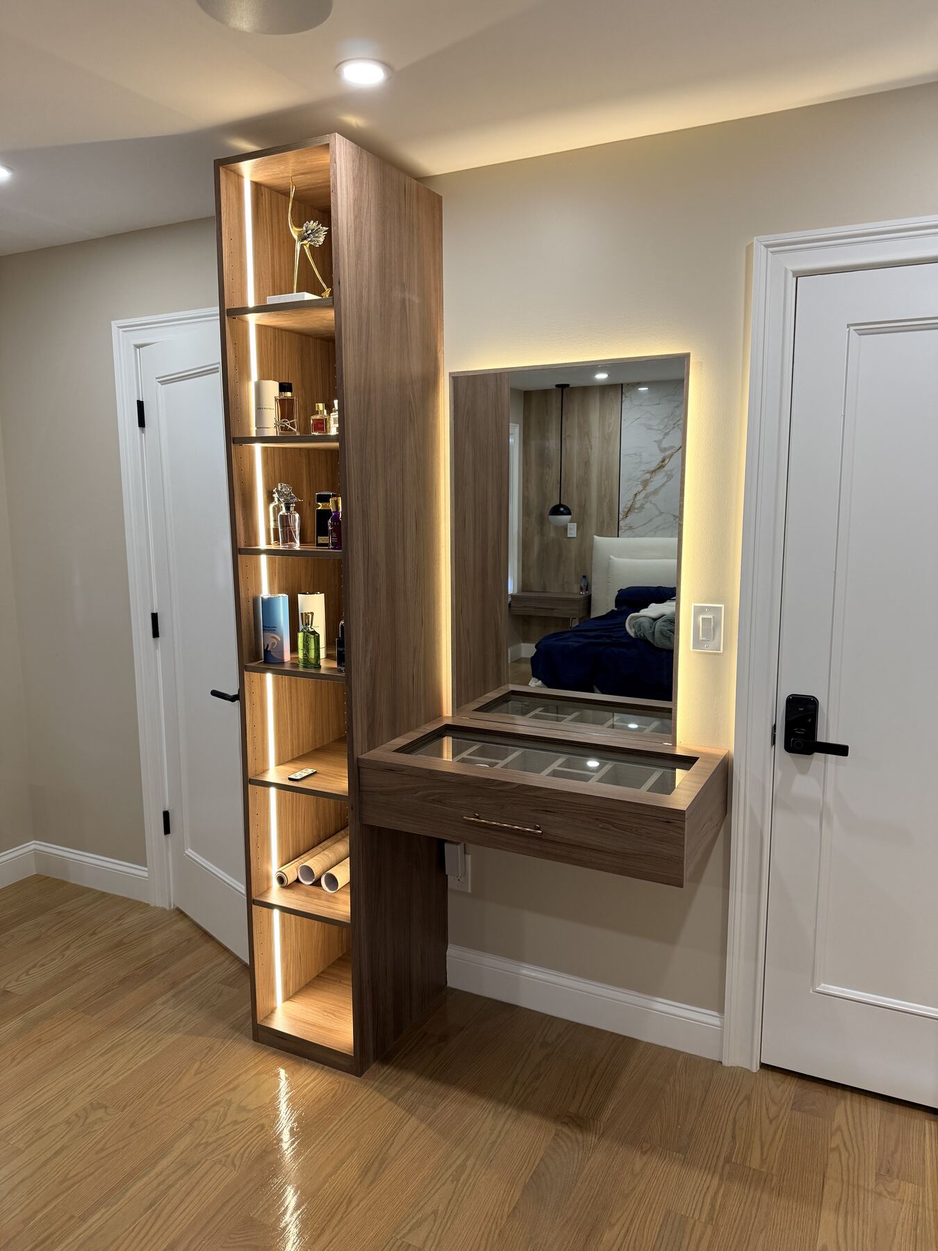 Floating make-up vanity with lit glass jewelry drawers and mirror