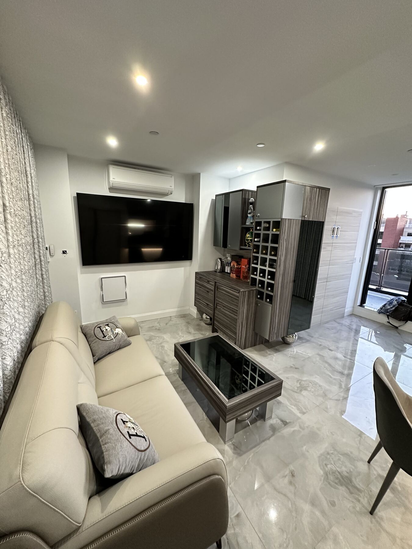Commercial office living space with media wall and wine storage